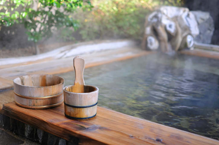 Japanese onsen hot spring with wooden bucket